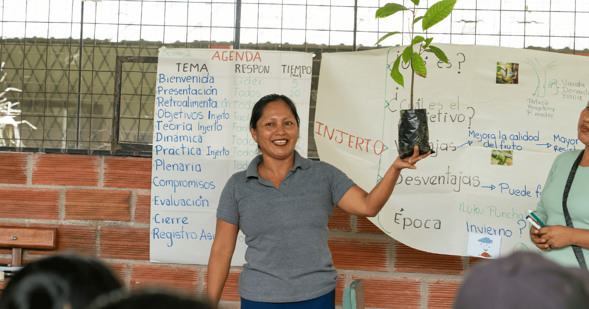 A woman holding a starter plant 