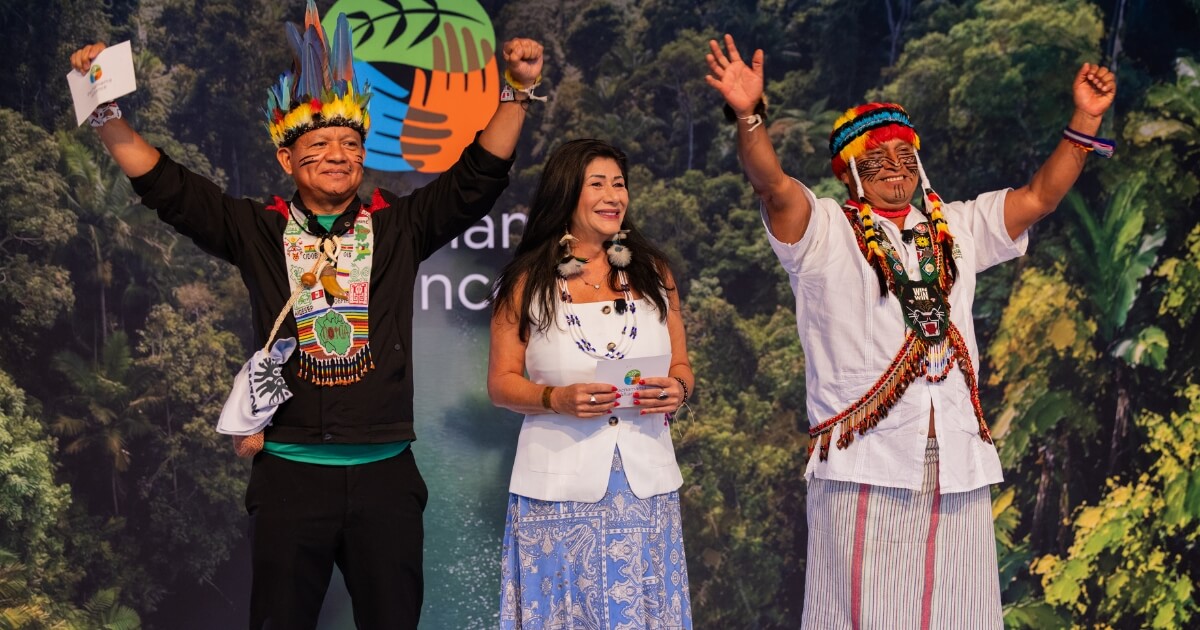 Gregorio Diaz Mirabal, International Affairs Advisor for Amazon Sacred HeadwatersAlliance (left) Alliance, Atossa Soltani, Founder of Amazon Watch, (right), and Domingo Peas, President of Amazon Sacred Headwaters Alliance, greet attendees from stage.