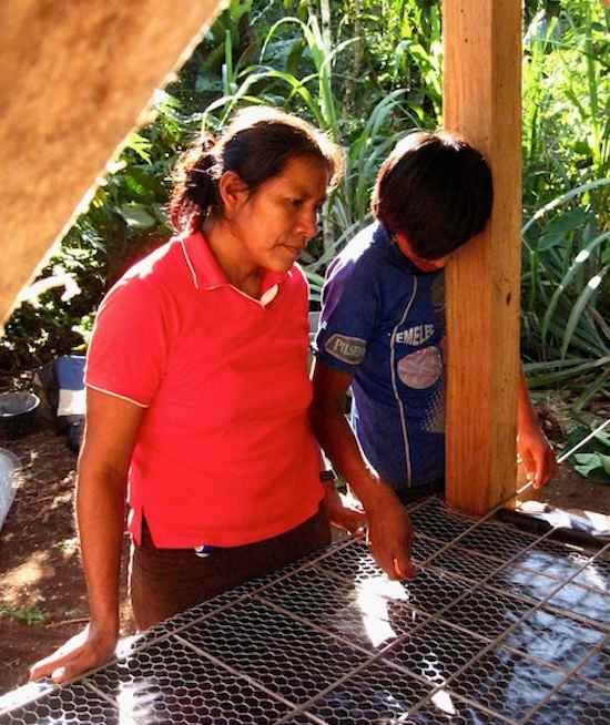 Achuar family building an ecological dry toilet