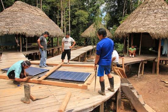 Framing solar panels for installation at Achuar ecolodge in Ecuadorean Amazon