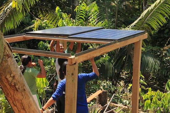 Installing solar panels at Achuar ecolodge in Ecuador's Amazon