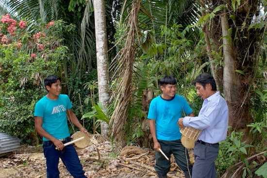 Men with drums at Sarayaku community celebration in the Ecuadorian rainforest