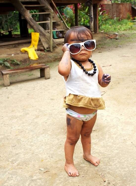Adorable young girl wearing sunglasses in Sarayaku, Ecuador