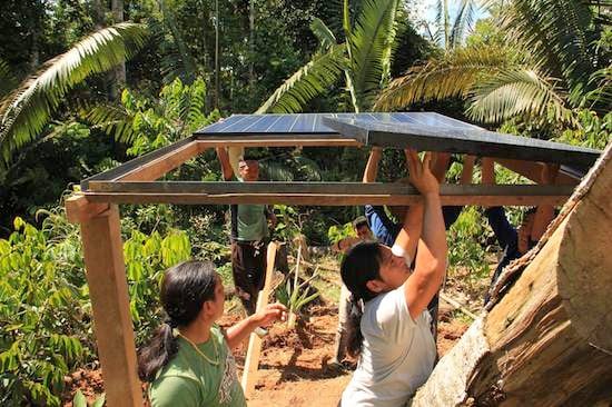 Completing installation of solar panels in an indigenous Achuar community