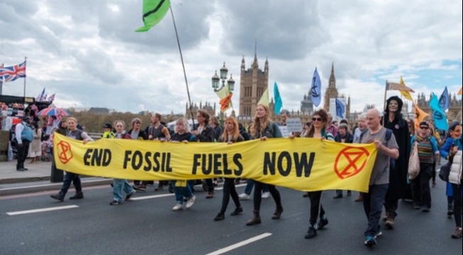 protestors with yellow end fossil fuels now banner 
