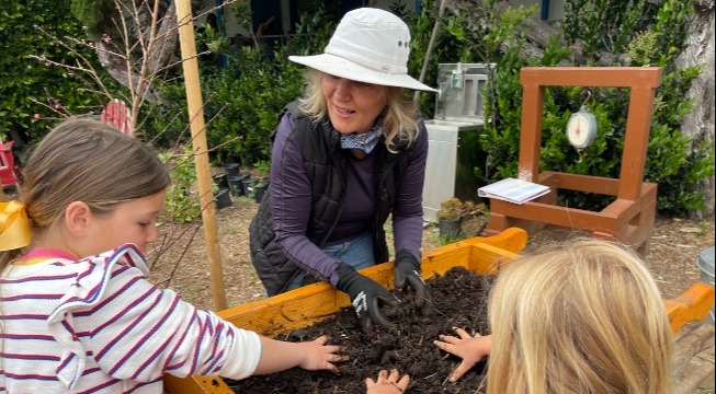 Cecilie Stuart sifting through soil with students