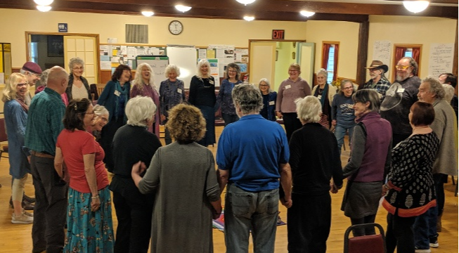 Community event participants hold hands